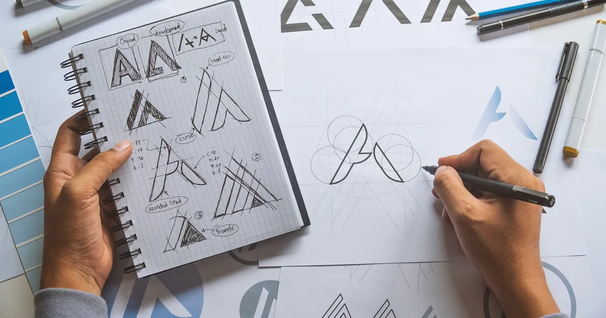Man drawing logo design concepts
